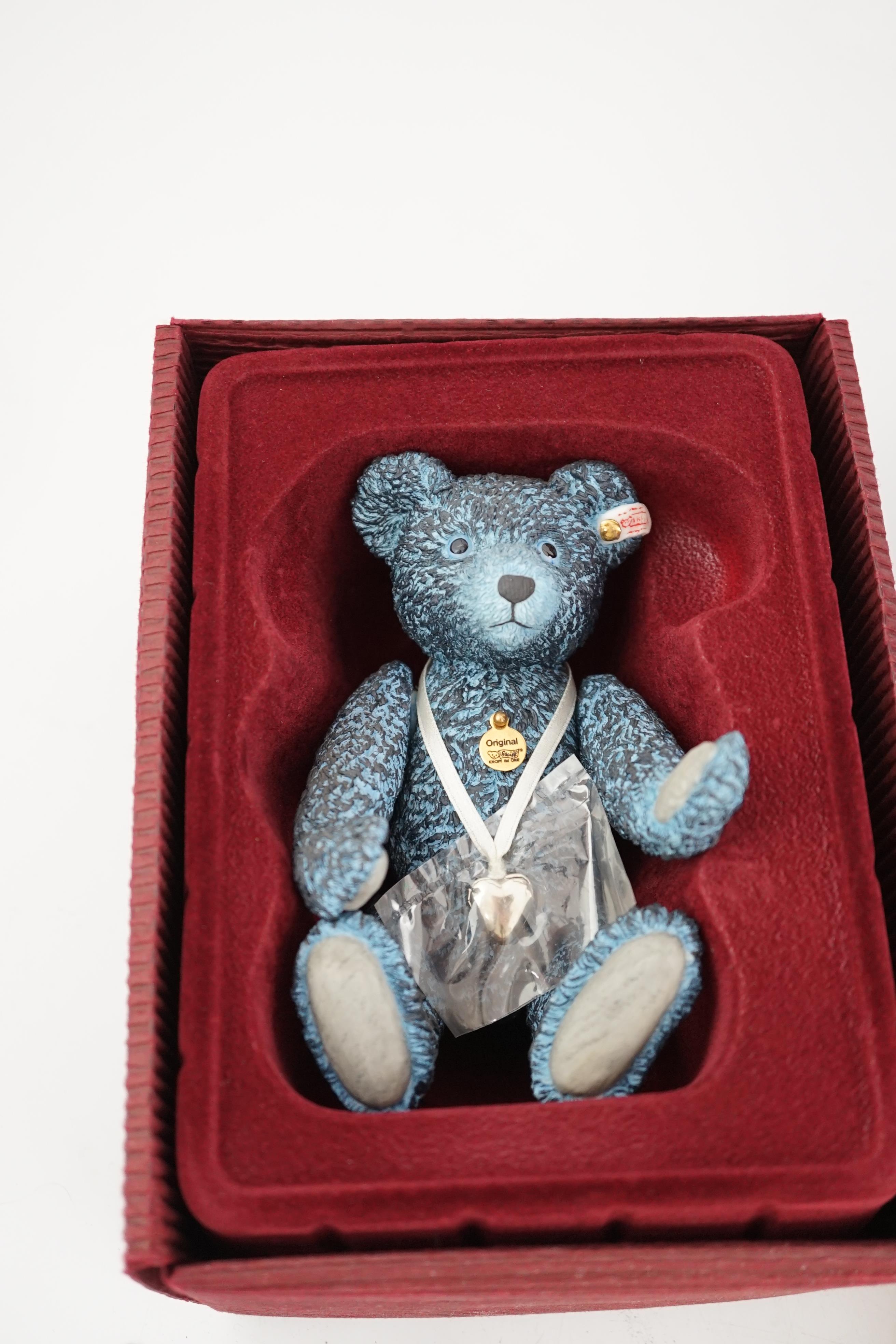An early Paddington bear, blue jacket, missing hat, a Steiff Ltd. edition lilac bear in box, and a porcelain Pelham puppet in box, good condition